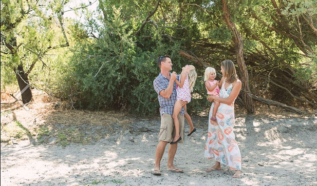 Caroline and Craig Makepeace of YTravelblog on the beach with their two beautiful daughters